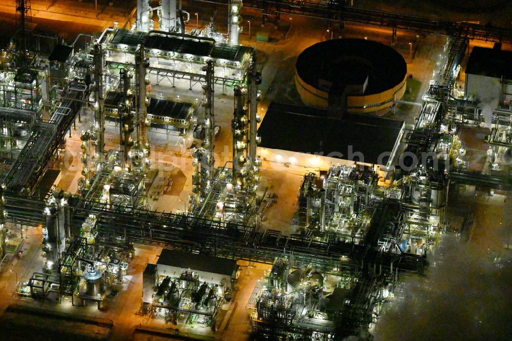Leuna at night from above - Night lighting refinery equipment and management systems on the factory premises of the chemical manufacturers on street Strasse der OdF in the district Spergau in Leuna in the state Saxony-Anhalt, Germany