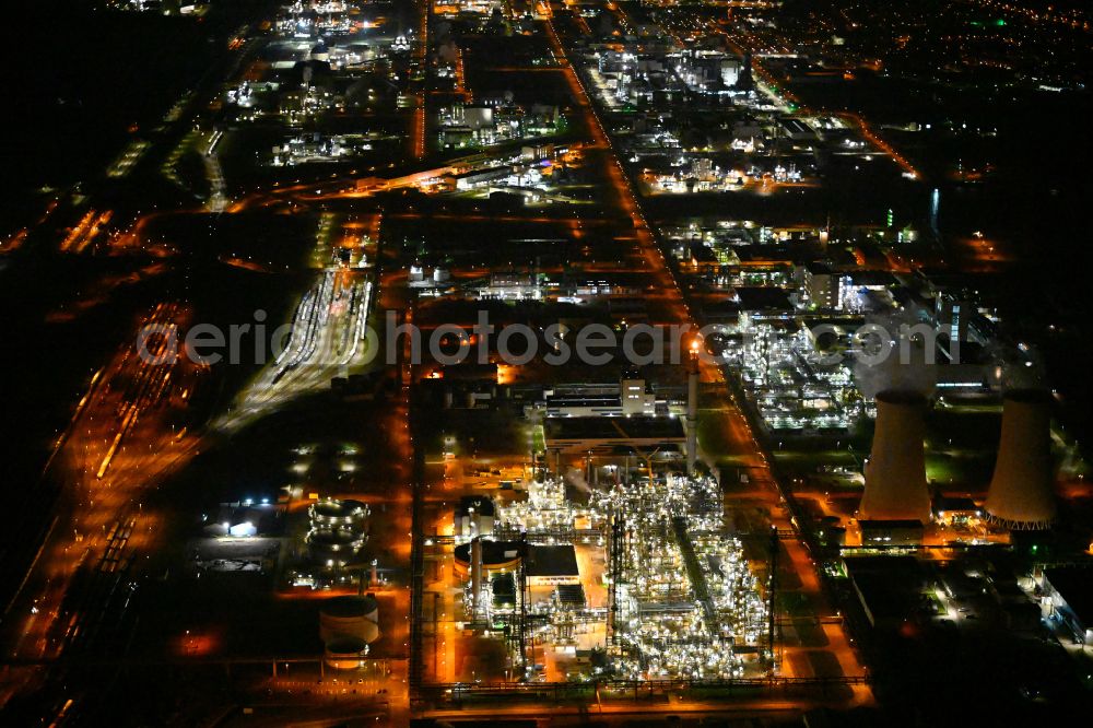 Aerial image at night Leuna - Night lighting refinery equipment and management systems on the factory premises of the chemical manufacturers on street Strasse der OdF in the district Spergau in Leuna in the state Saxony-Anhalt, Germany