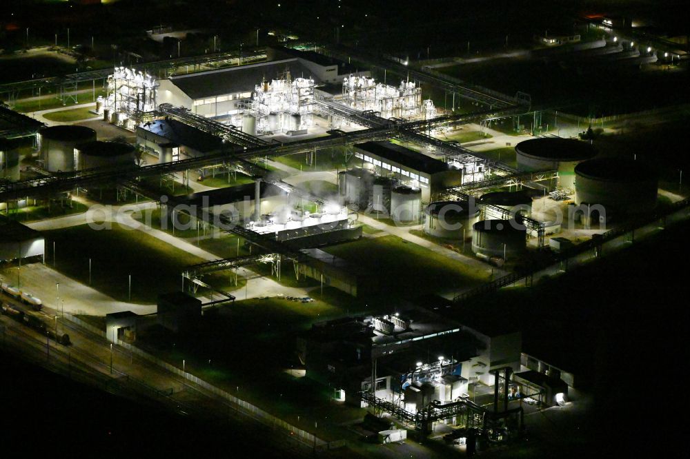 Aerial image at night Bitterfeld - Night lighting refinery equipment and management systems on the factory premises of the chemical manufacturers Nobian GmbH on street Elektrolysestrasse in Bitterfeld in the state Saxony-Anhalt, Germany