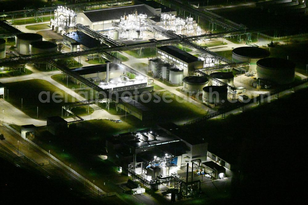 Bitterfeld at night from above - Night lighting refinery equipment and management systems on the factory premises of the chemical manufacturers Nobian GmbH on street Elektrolysestrasse in Bitterfeld in the state Saxony-Anhalt, Germany