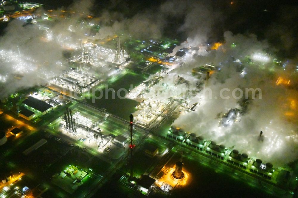 Aerial image at night Lippendorf - Night lighting Refinery equipment and management systems on the factory premises of the mineral oil manufacturers in Lippendorf in the state Saxony, Germany