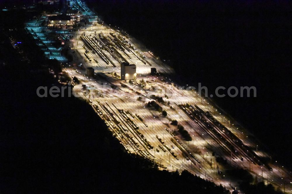 Aerial photograph at night Neuseddin - Night lighting marshalling yard and freight station of the Deutsche Bahn in Neuseddin in the state Brandenburg