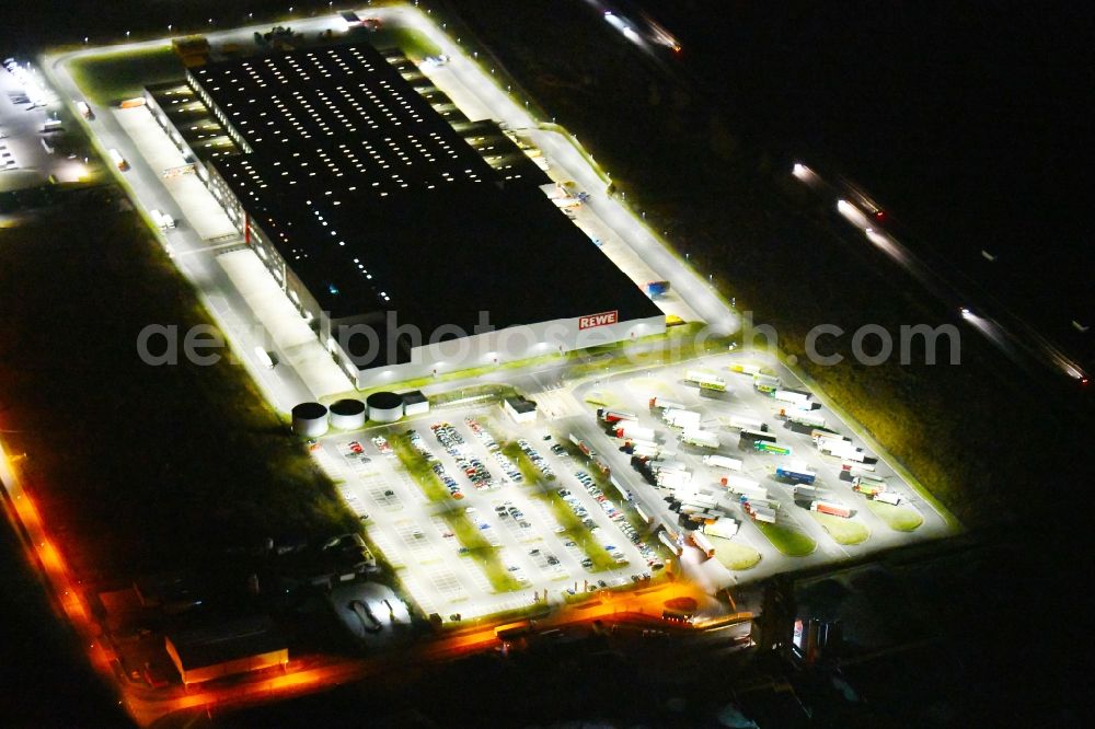 Aerial image at night Oranienburg - Night lighting Warehouses and forwarding building of REWE- Logistikzentrum on Rewestrasse in the district Borgsdorf in Oranienburg in the state Brandenburg, Germany
