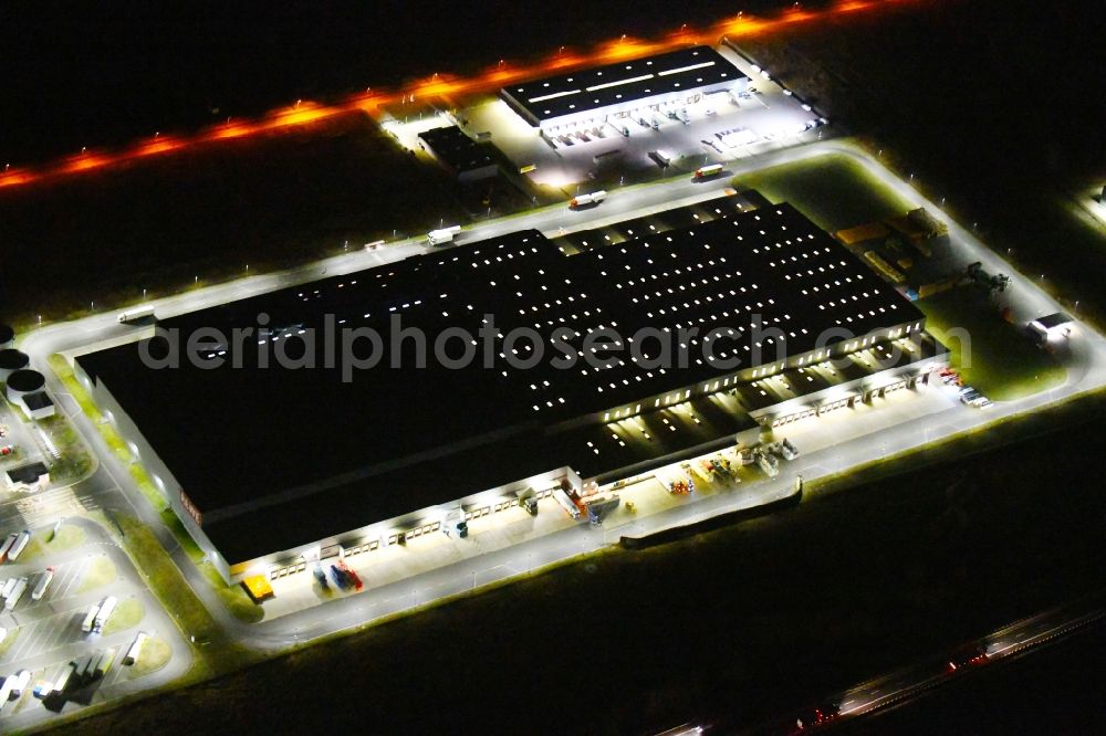 Aerial image at night Oranienburg - Night lighting Warehouses and forwarding building of REWE- Logistikzentrum on Rewestrasse in the district Borgsdorf in Oranienburg in the state Brandenburg, Germany