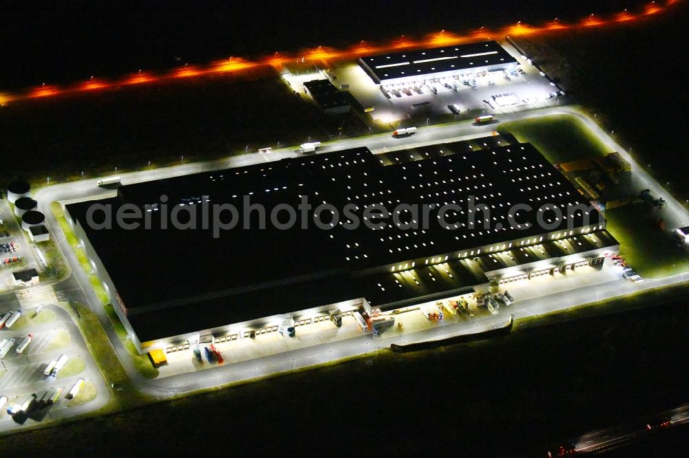 Oranienburg at night from above - Night lighting Warehouses and forwarding building of REWE- Logistikzentrum on Rewestrasse in the district Borgsdorf in Oranienburg in the state Brandenburg, Germany