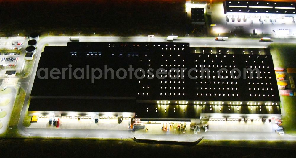 Oranienburg at night from above - Night lighting Warehouses and forwarding building of REWE- Logistikzentrum on Rewestrasse in the district Borgsdorf in Oranienburg in the state Brandenburg, Germany