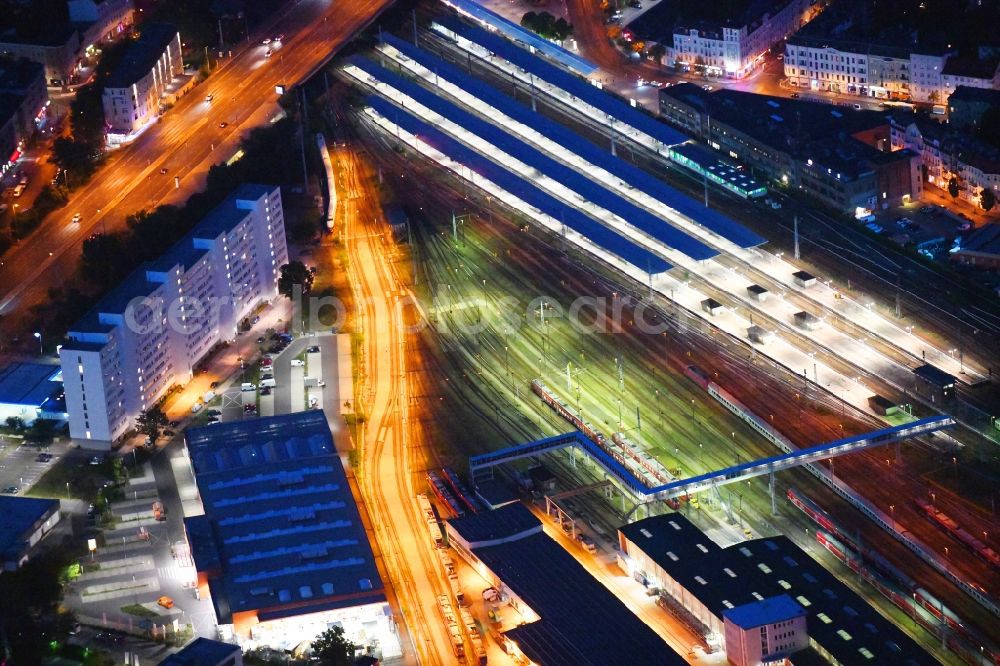 Aerial photograph at night Berlin - Night lighting railway track and overhead wiring harness in the route network of the Deutsche Bahn in the district Lichtenberg in Berlin, Germany