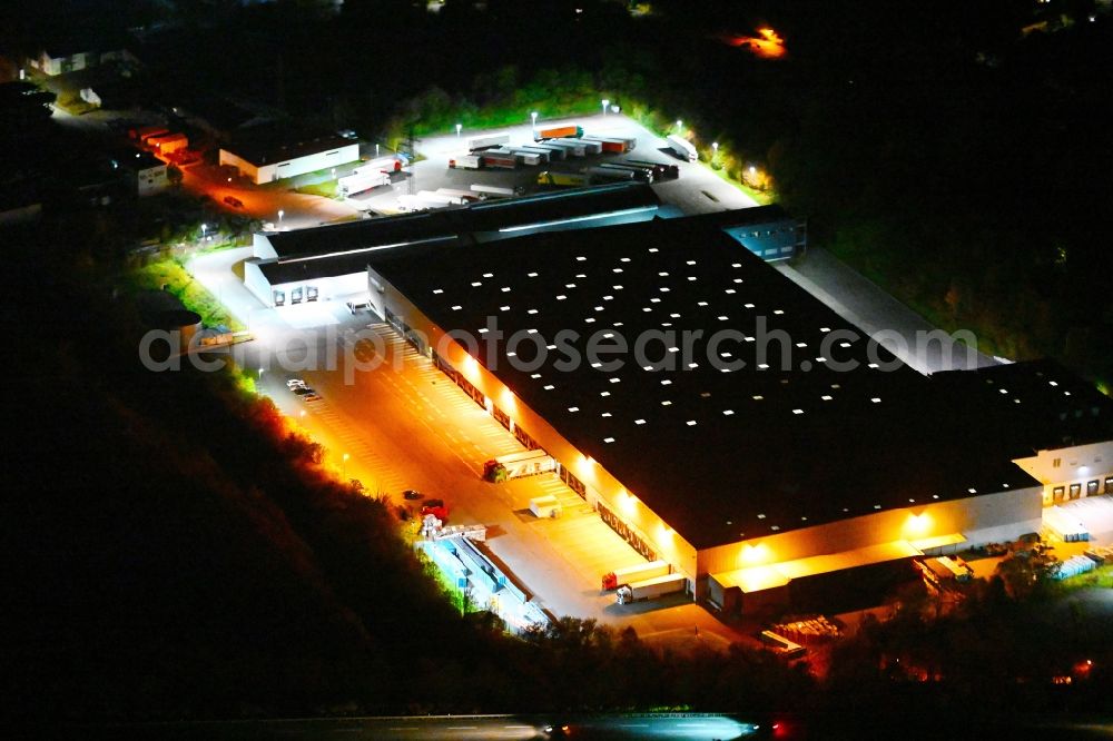 Aerial image at night Friedrichsthal - Night lighting warehouses and forwarding building of Lidl Vertriebs GmbH & Co. KG (Zentrallager) Am Grubenbahnhof in Friedrichsthal in the state Saarland, Germany