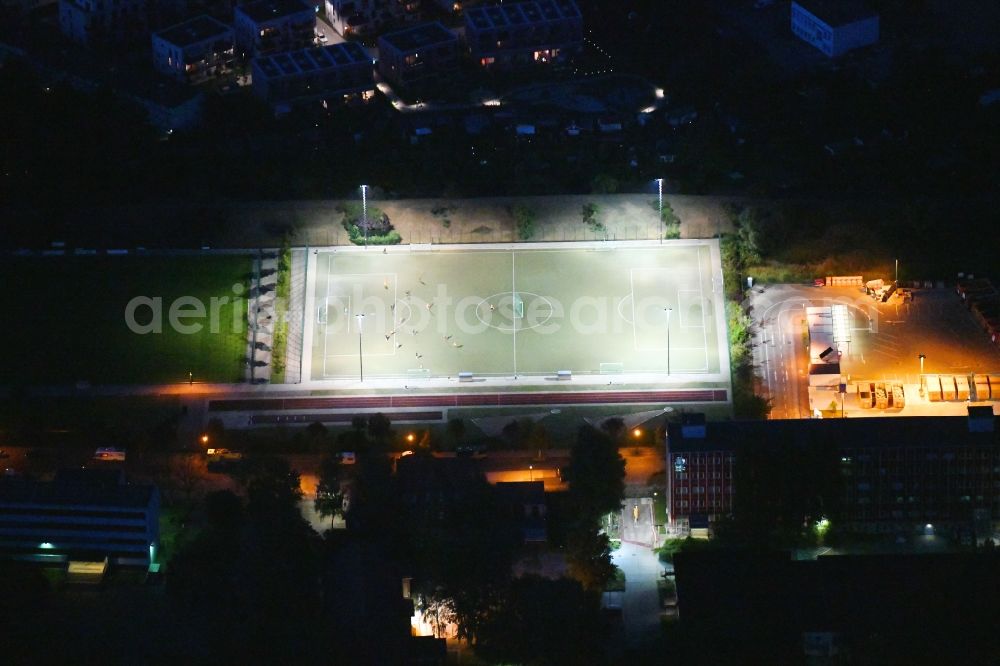 Berlin at night from above - Night lighting sports grounds and football pitch on Fischerstrasse in the district Rummelsburg in Berlin, Germany