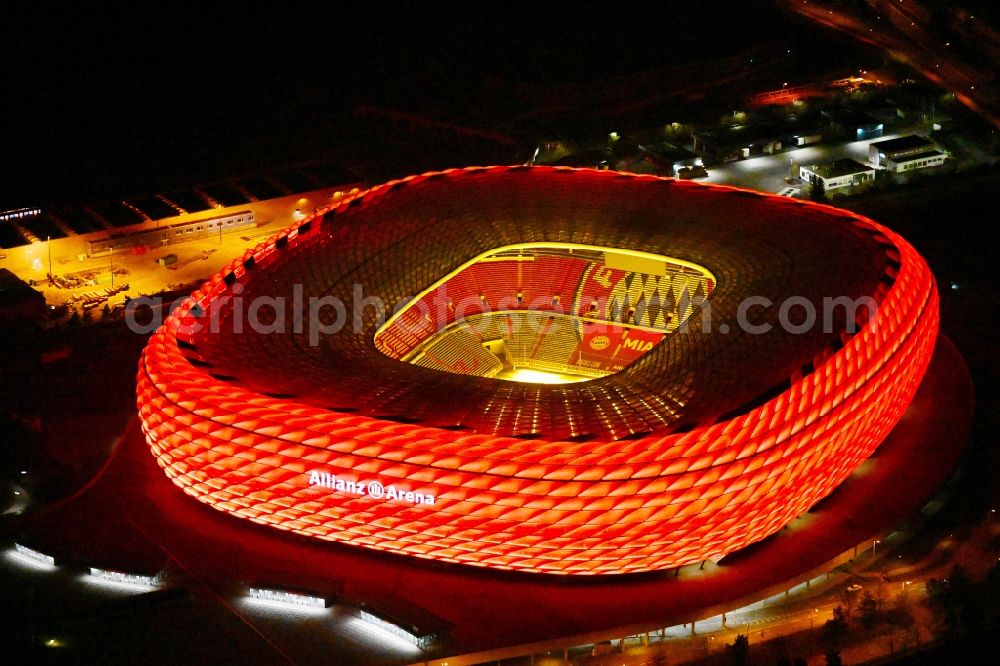 Aerial image at night München - Night lighting sports facility grounds of the Arena stadium Allianz Arena on Werner-Heisenberg-Allee in Munich in the state Bavaria, Germany