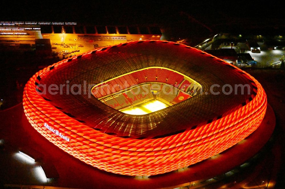 München at night from above - Night lighting sports facility grounds of the Arena stadium Allianz Arena on Werner-Heisenberg-Allee in Munich in the state Bavaria, Germany