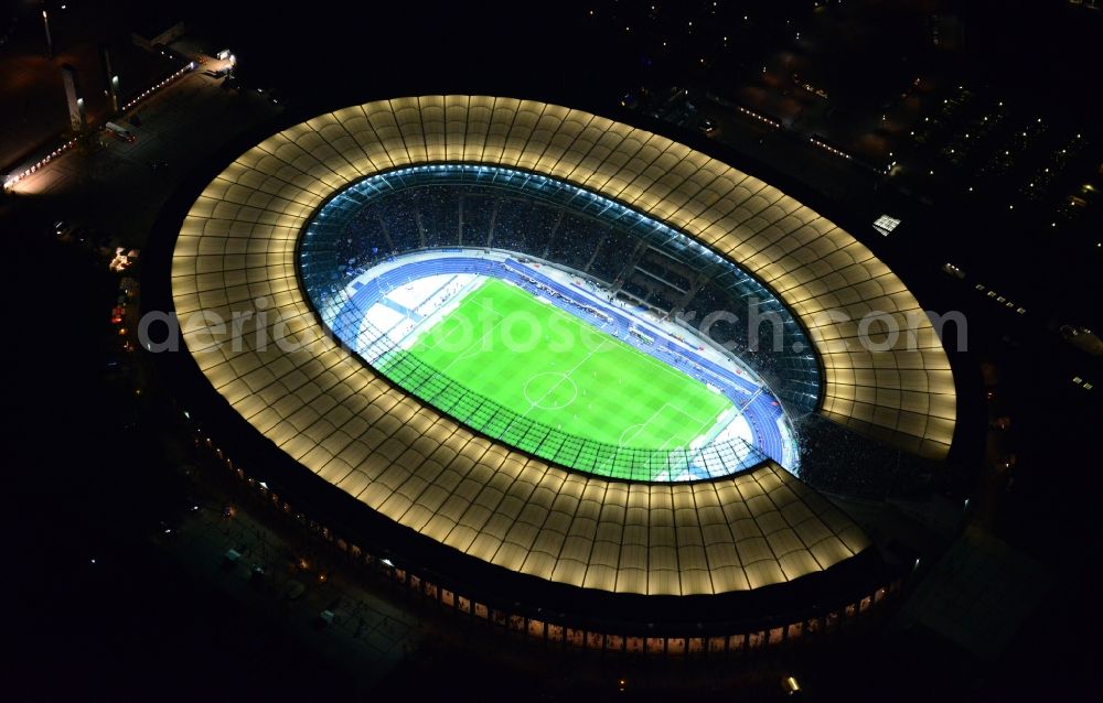 Aerial image at night Berlin - Night lighting Sports facility grounds of the Arena stadium Olympiastadion of Hertha BSC in Berlin in Germany