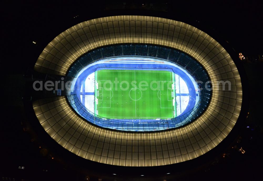 Berlin at night from above - Night lighting Sports facility grounds of the Arena stadium Olympiastadion of Hertha BSC in Berlin in Germany