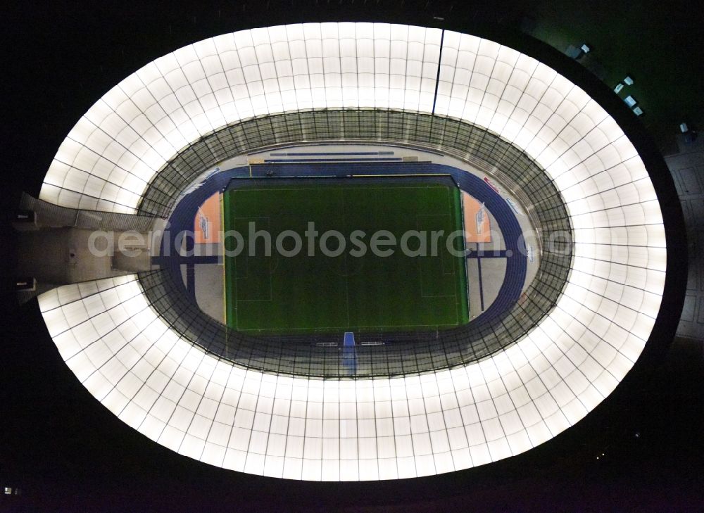 Aerial photograph at night Berlin - Night lighting sports facility grounds of the Arena stadium Olympiastadion of Hertha BSC in Berlin in Germany