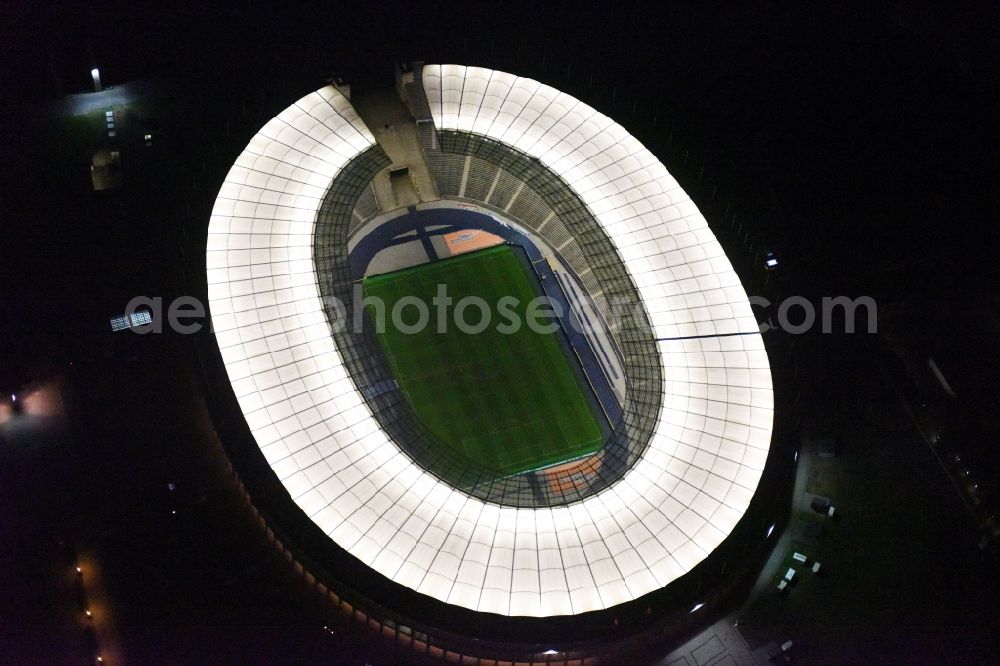Aerial image at night Berlin - Night lighting sports facility grounds of the Arena stadium Olympiastadion of Hertha BSC in Berlin in Germany