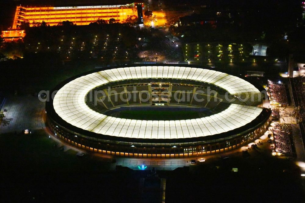 Berlin at night from above - Night lighting sports facility grounds of the Arena stadium Olympiastadion of Hertha BSC in Berlin in Germany