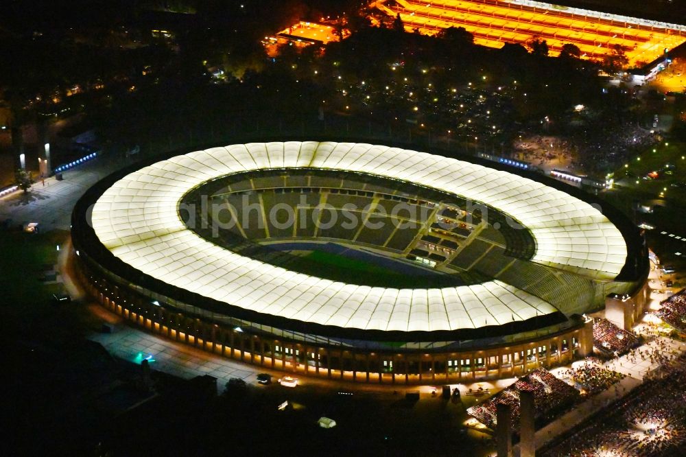 Berlin at night from the bird perspective: Night lighting sports facility grounds of the Arena stadium Olympiastadion of Hertha BSC in Berlin in Germany