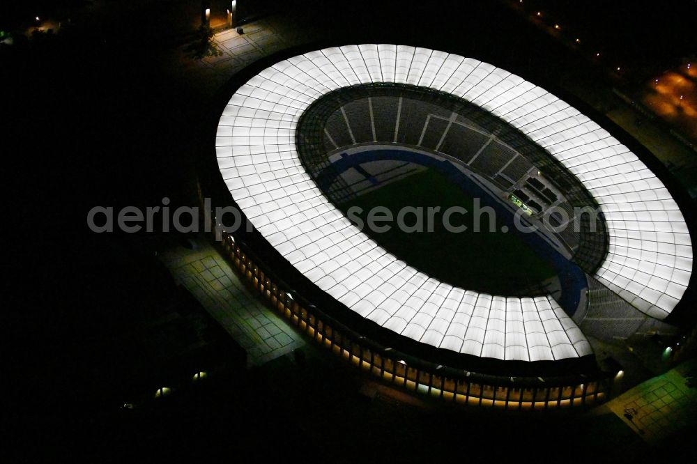 Aerial image at night Berlin - Night lighting sports facility grounds of the Arena stadium Olympiastadion of Hertha BSC in Berlin in Germany