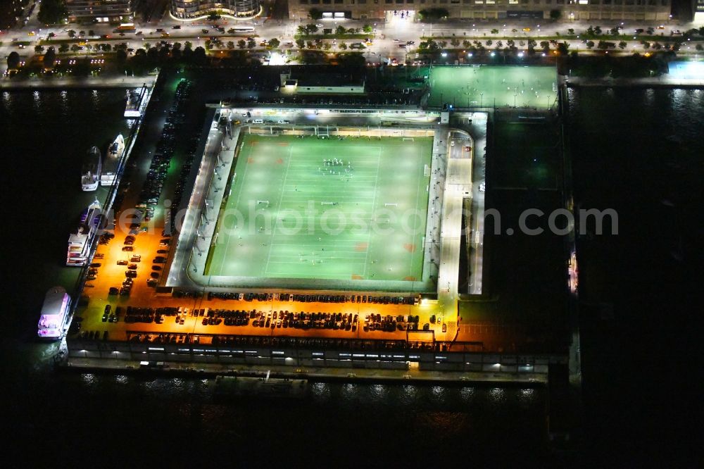 New York at night from above - Night lighting Sports facility grounds of the Arena stadium Pier 40 at Soccer Field on Hudson River Park in the district Manhattan in New York in United States of America