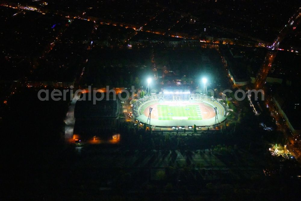 Aerial image at night Berlin - Night lighting Stadium at the Friedrich-Ludwig-Jahn-Sportpark in Berlin Prenzlauer Berg
