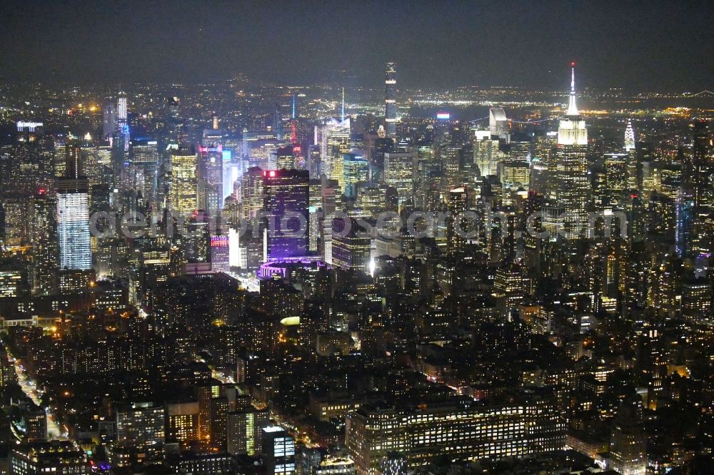 Aerial image at night New York - Night lighting City view of the city area of in the district Manhattan in New York in United States of America