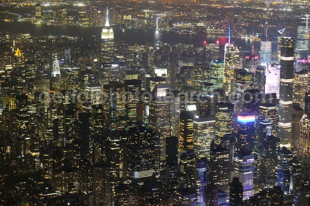 New York at night from the bird perspective: Night lighting City view of the city area of in the district Manhattan in New York in United States of America