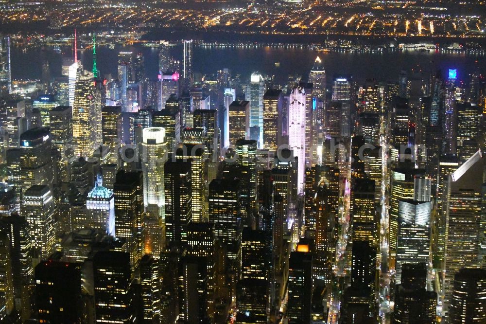 Aerial photograph at night New York - Night lighting City view of the city area of in the district Manhattan in New York in United States of America