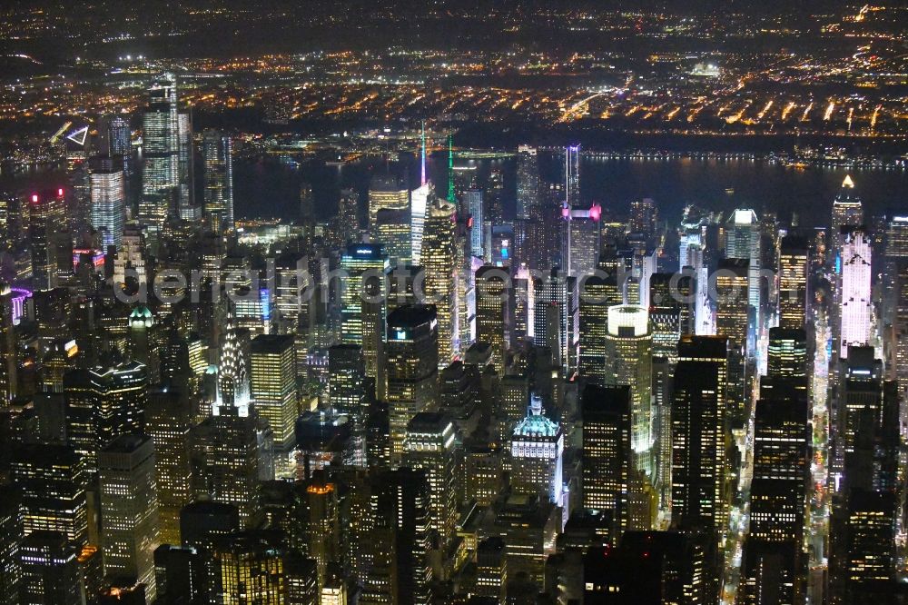 Aerial image at night New York - Night lighting City view of the city area of in the district Manhattan in New York in United States of America