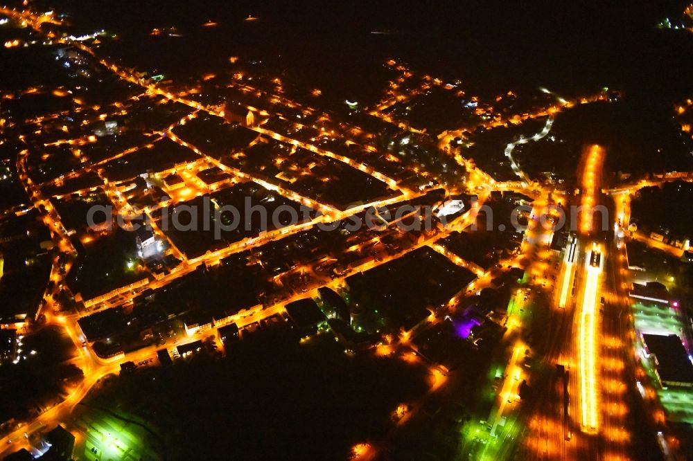 Aerial photograph at night Angermünde - Night lighting City view of downtown area at the train station in Angermuende in the state Brandenburg, Germany