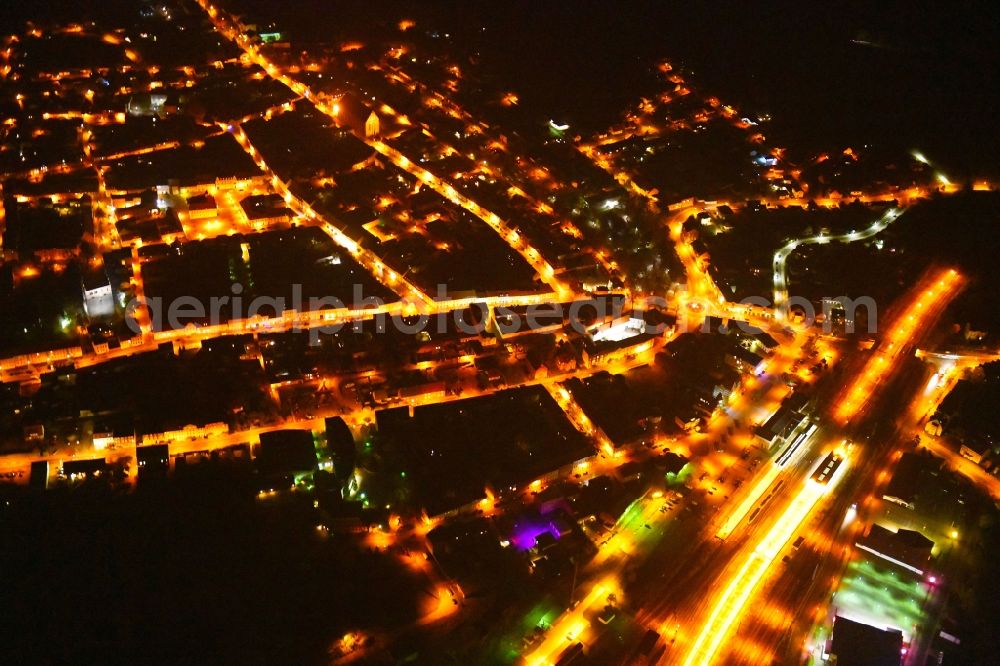 Aerial image at night Angermünde - Night lighting City view of downtown area at the train station in Angermuende in the state Brandenburg, Germany