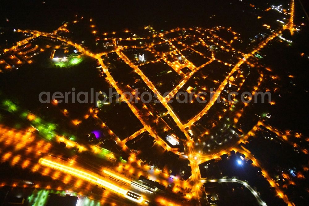 Aerial photograph at night Angermünde - Night lighting City view of downtown area at the train station in Angermuende in the state Brandenburg, Germany