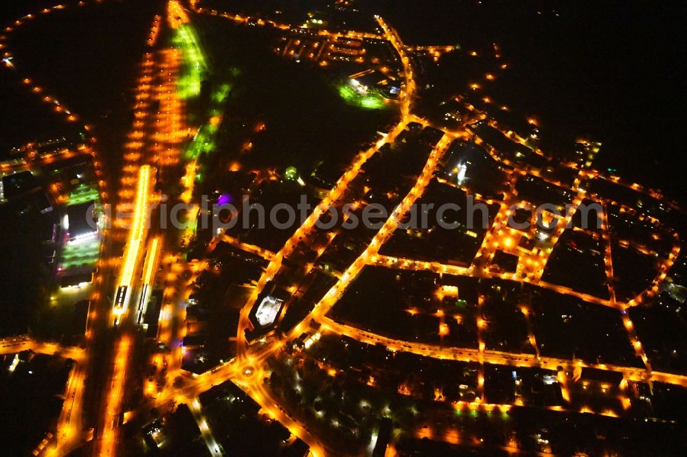 Aerial image at night Angermünde - Night lighting City view of downtown area at the train station in Angermuende in the state Brandenburg, Germany