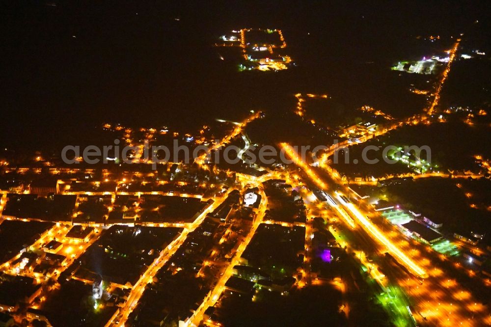 Angermünde at night from the bird perspective: Night lighting City view of downtown area at the train station in Angermuende in the state Brandenburg, Germany