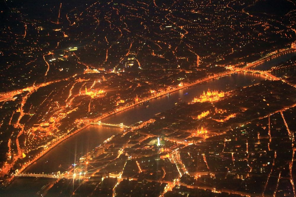 Aerial photograph at night Budapest - Night lighting city view on the river bank of the river Danube in Budapest in Hungary