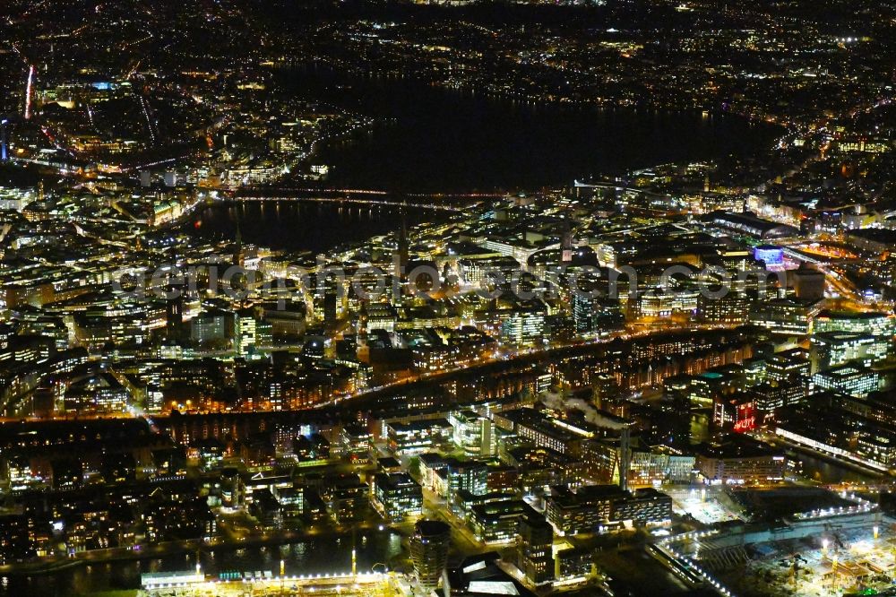 Aerial image at night Hamburg - Night lighting city view on the river bank of the River Elbe in the district HafenCity in Hamburg, Germany