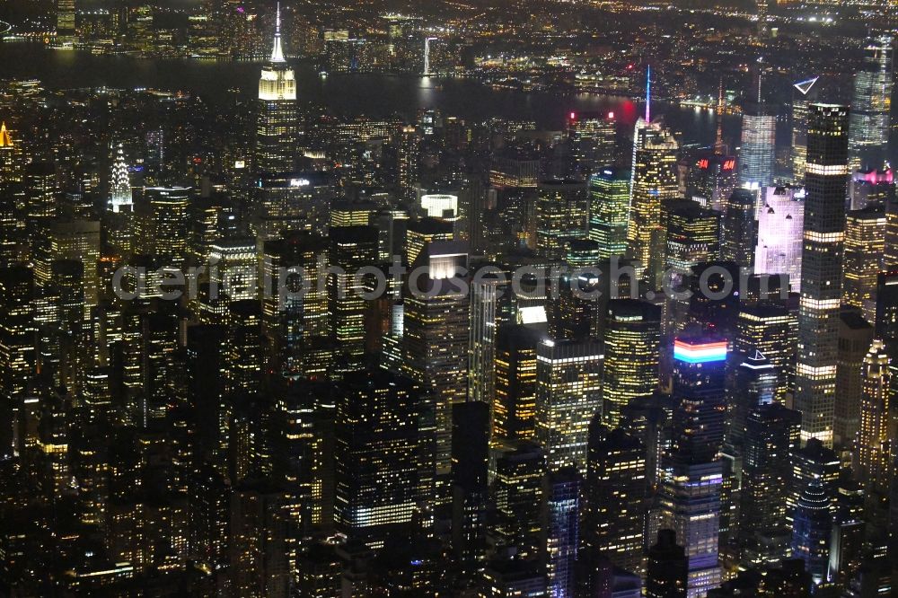 Aerial image at night New York - Night lighting City center with the skyline in the downtown area on Broadway in the district Manhattan in New York in United States of America