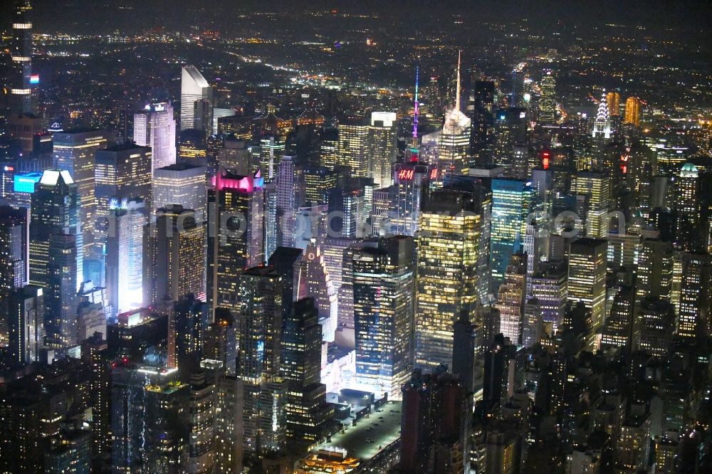 Aerial photograph at night New York - Night lighting City center with the skyline in the downtown area Broadway - Times Square - Seventh Avenue in the district Manhattan in New York in United States of America