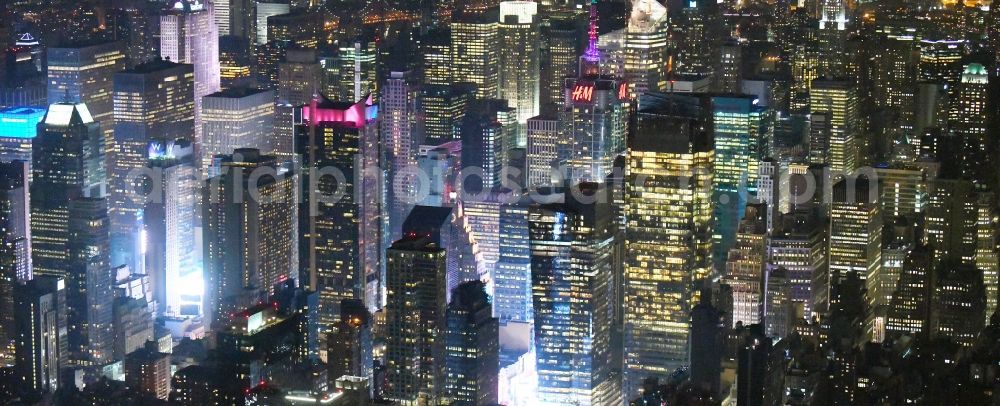 Aerial image at night New York - Night lighting City center with the skyline in the downtown area Broadway - Times Square - Seventh Avenue in the district Manhattan in New York in United States of America