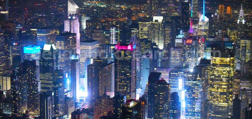 New York at night from the bird perspective: Night lighting City center with the skyline in the downtown area Broadway - Times Square - Seventh Avenue in the district Manhattan in New York in United States of America
