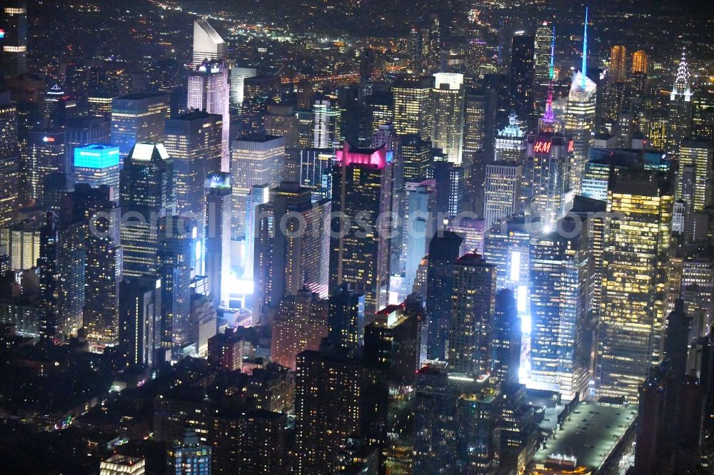 Aerial photograph at night New York - Night lighting City center with the skyline in the downtown area Broadway - Times Square - Seventh Avenue in the district Manhattan in New York in United States of America