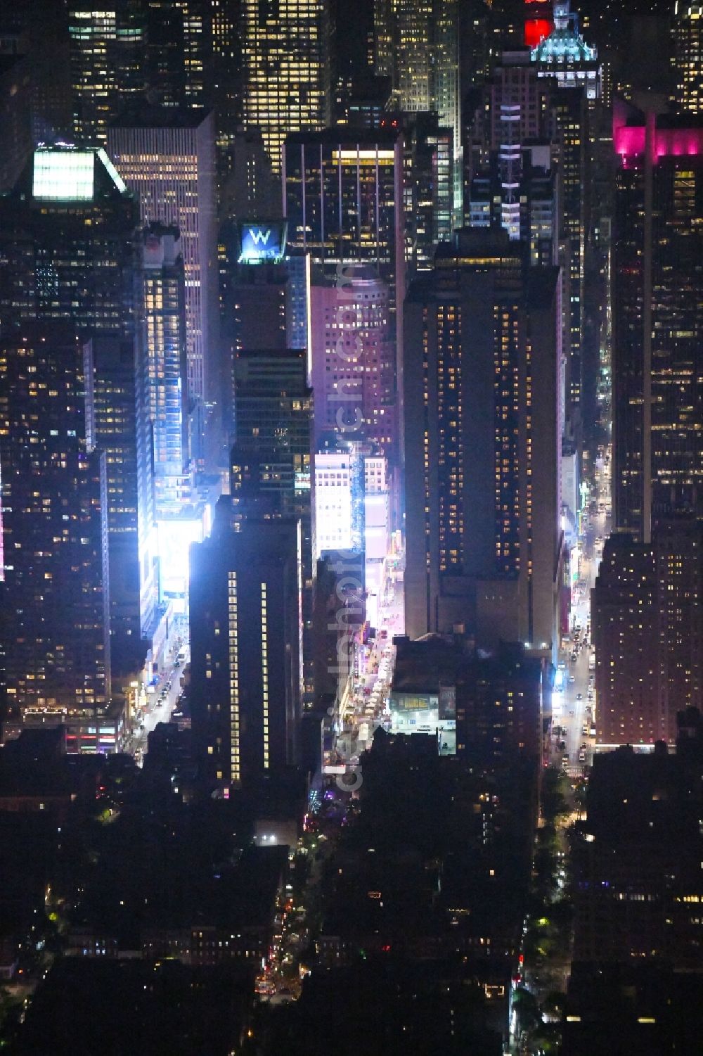 Aerial photograph at night New York - Night lighting City center with the skyline between Times Squar - Broadway in the downtown area in the district Manhattan in New York in United States of America