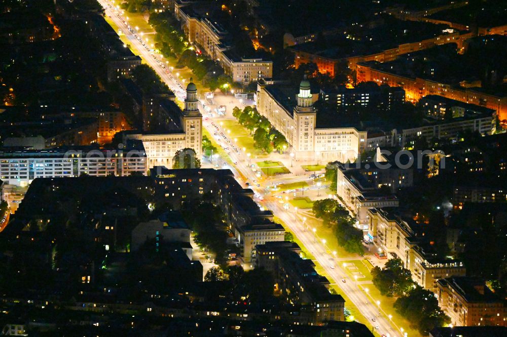 Aerial photograph at night Berlin - Night view of street guide of famous promenade and shopping street Frankfurter Allee - place Frankfurter Tor and formerly cinema building KOSMOS destrict Friedrichshain in Berlin