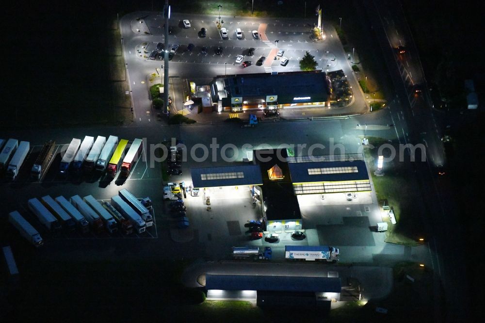 Dissen am Teutoburger Wald at night from above - Night lighting Gas station for sale of petrol and diesel fuels and mineral oil trade L-Port in Dissen am Teutoburger Wald in the state Lower Saxony, Germany