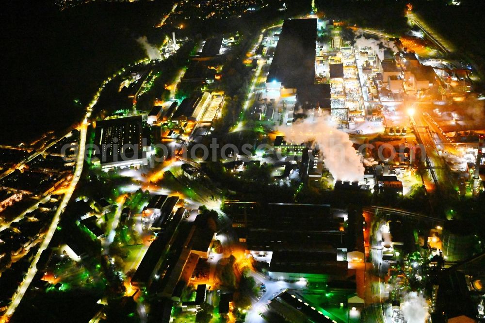 Dillingen/Saar at night from the bird perspective: Night lighting technical equipment and production facilities of the steelworks Zentralkokerei Saar GmbH in Dillingen/Saar in the state Saarland, Germany