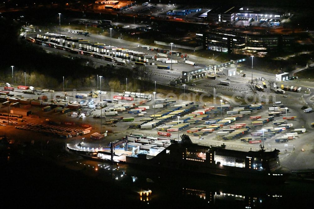 Aerial image at night Travemünde - Night lighting building complex and distribution center on the site of Terminal Skandinavienkai in the district Ivendorf in Travemuende in the state Schleswig-Holstein, Germany