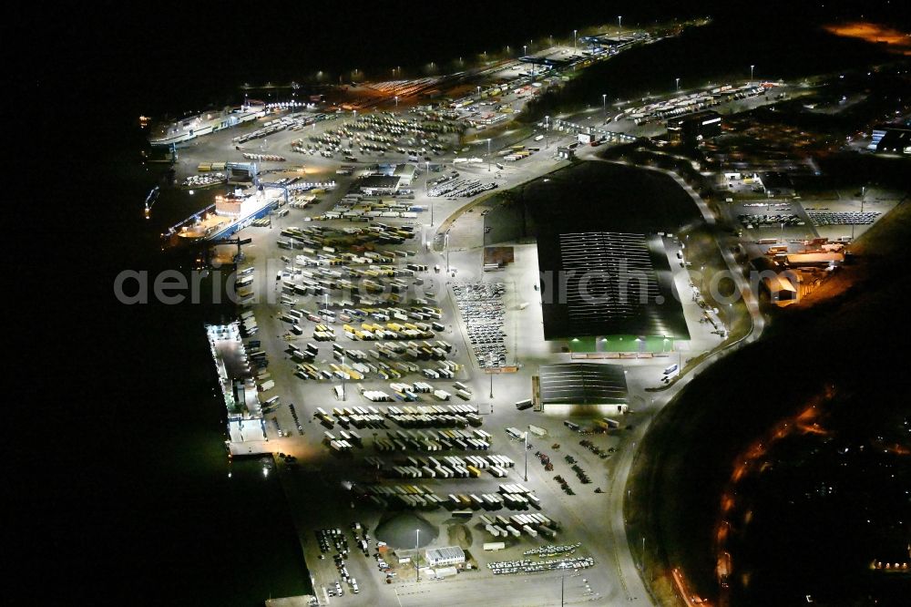 Aerial photograph at night Travemünde - Night lighting building complex and distribution center on the site of Terminal Skandinavienkai in the district Ivendorf in Travemuende in the state Schleswig-Holstein, Germany