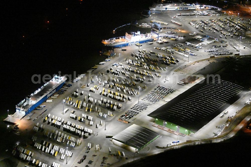 Travemünde at night from the bird perspective: Night lighting building complex and distribution center on the site of Terminal Skandinavienkai in the district Ivendorf in Travemuende in the state Schleswig-Holstein, Germany