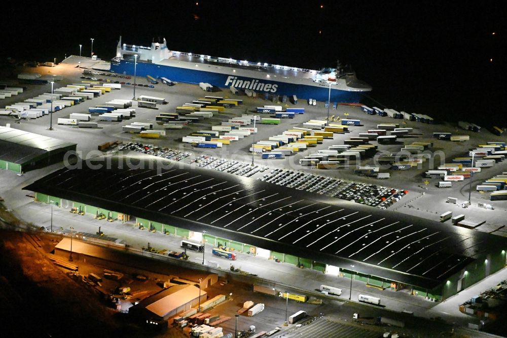 Aerial image at night Travemünde - Night lighting building complex and distribution center on the site of Terminal Skandinavienkai in the district Ivendorf in Travemuende in the state Schleswig-Holstein, Germany