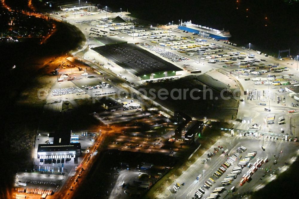 Travemünde at night from the bird perspective: Night lighting building complex and distribution center on the site of Terminal Skandinavienkai in the district Ivendorf in Travemuende in the state Schleswig-Holstein, Germany