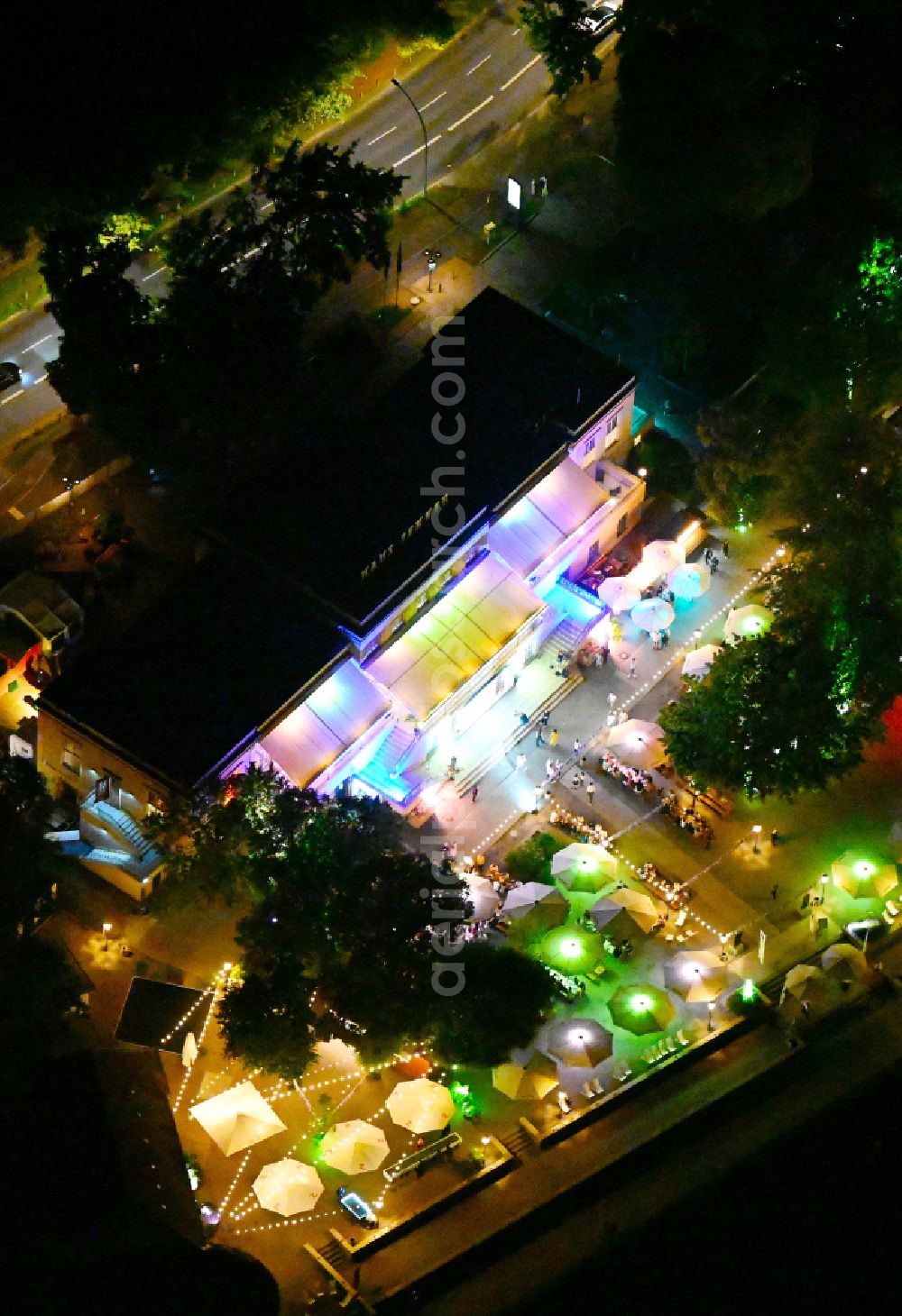 Berlin at night from above - Night lighting tables and benches of open-air restaurant Haus Zenner on street Alt-Treptow in the district Treptow in Berlin, Germany